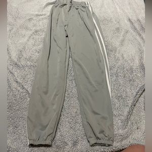 Light grey joggers with white stripe, size M